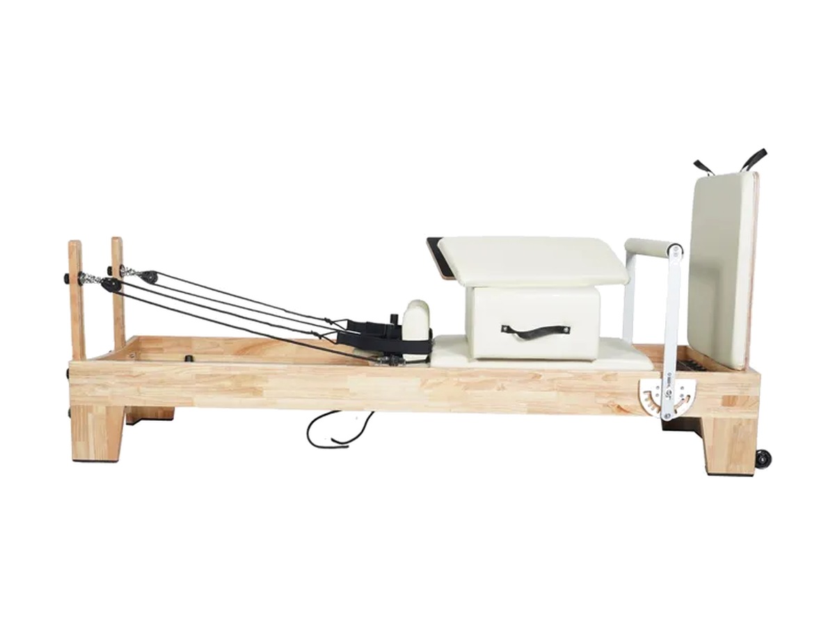 Reformer de madera clara con tapizado crema, cajón con asa y respaldo